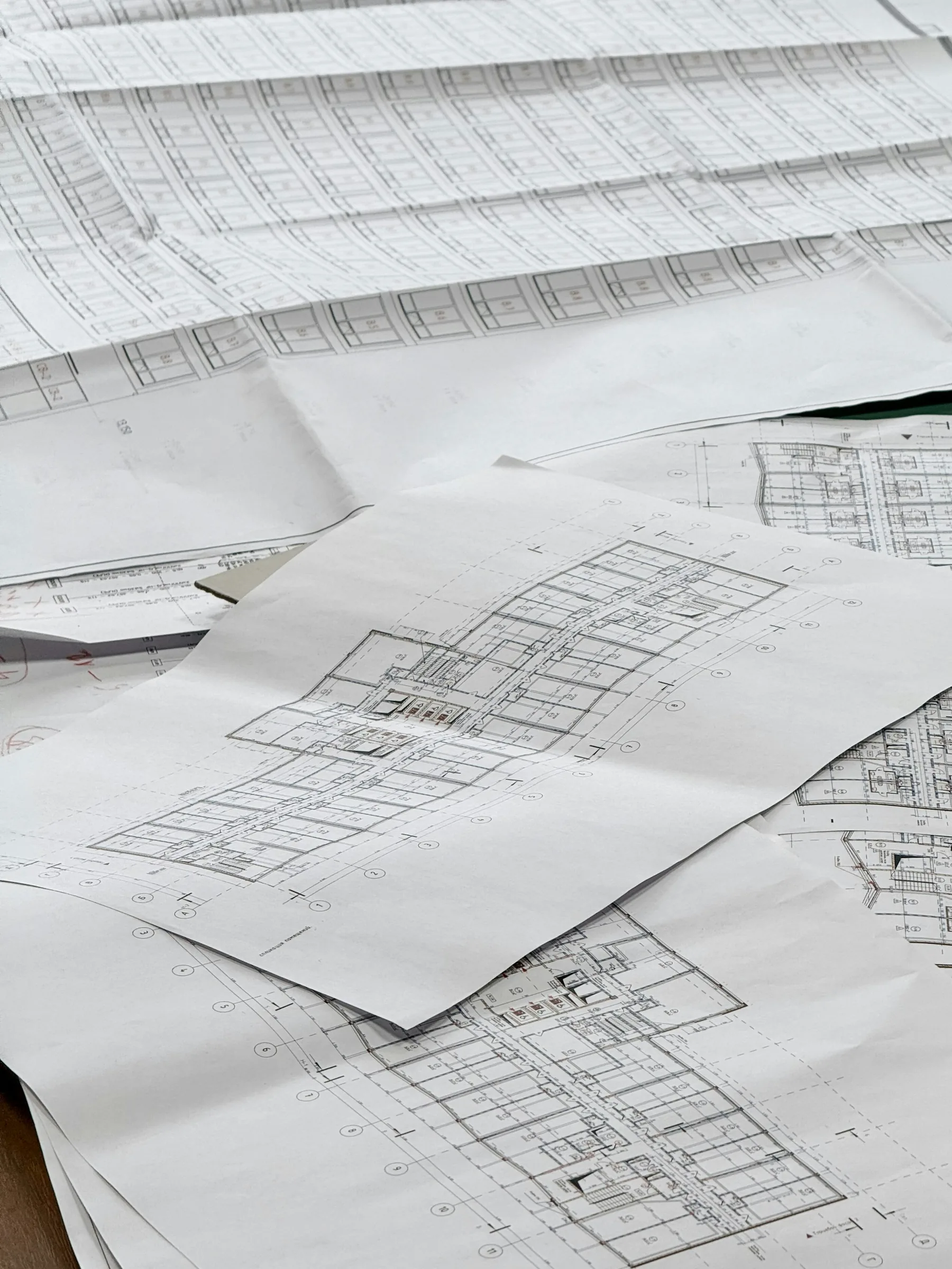 Architectural plans and measuring tools on a working desk.